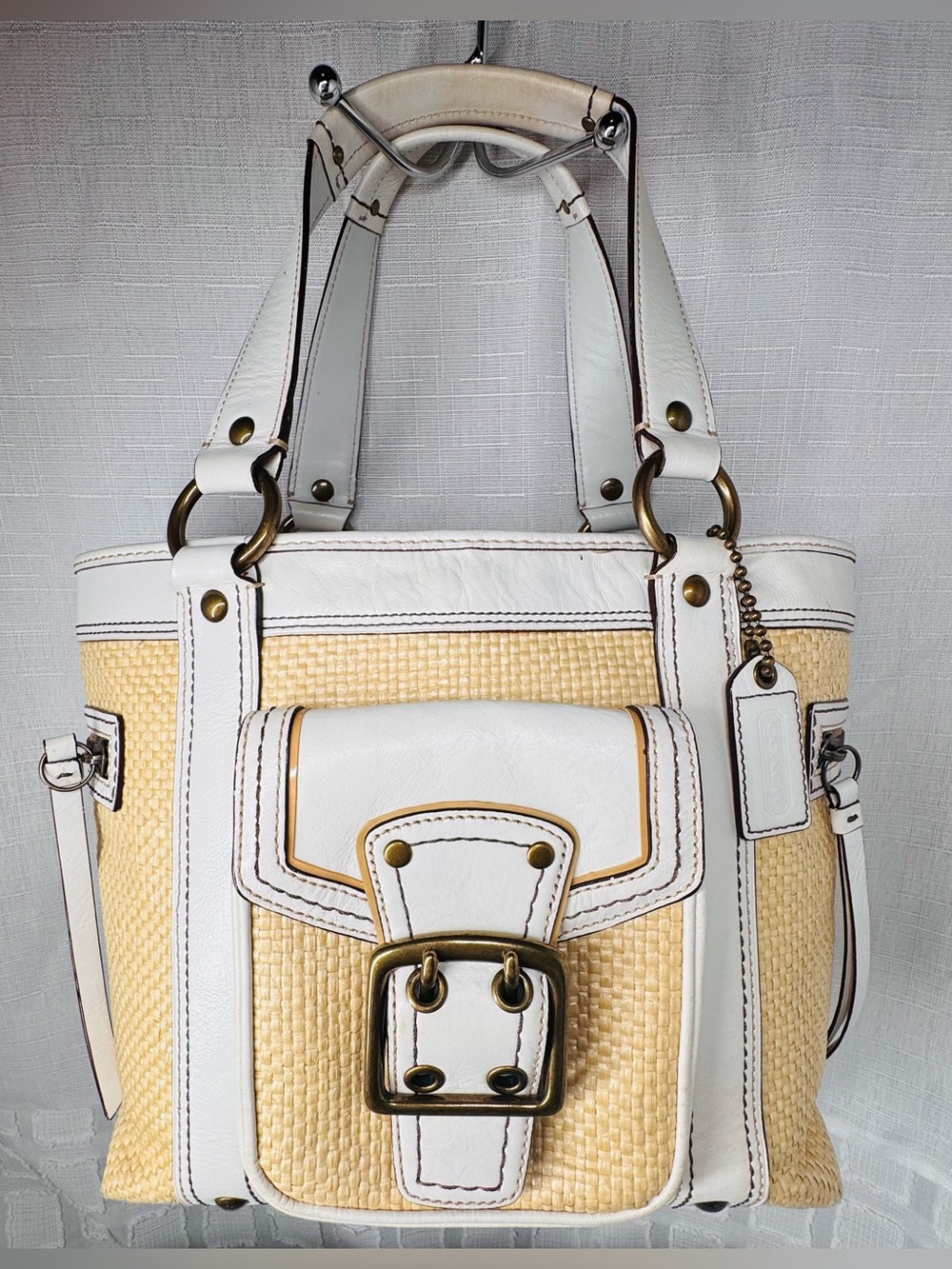 Coach vintage Legacy straw and white leather tote handbag with brass hardware.